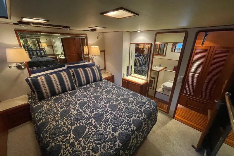 Slide: The Image of Luxurious bedroom interior of 1990 Offshore Yachts 55 Pilothouse with elegant bedding and ensuite bathroom. - 20
