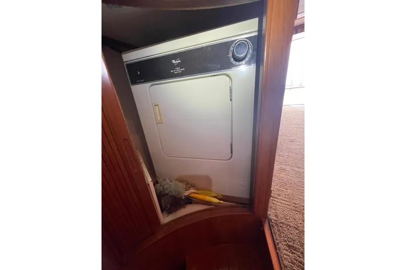 Slide: The Image of Laundry area with dryer inside 1990 Offshore Yachts 55 Pilothouse. - 25
