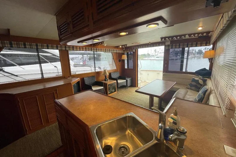 Slide: The Image of Interior of 1990 Offshore Yachts 55 Pilothouse with cozy seating and large windows. - 3