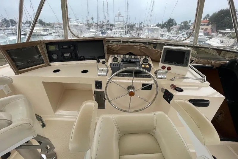 Slide: The Image of Cockpit of 1990 Offshore Yachts 55 Pilothouse with steering wheel and navigation equipment. - 31