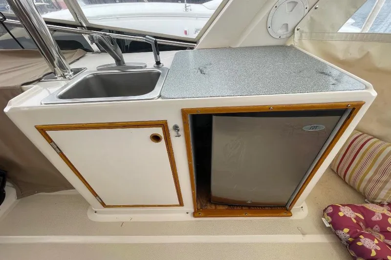 Slide: The Image of 1990 Offshore Yachts 55 Pilothouse kitchenette with sink and mini fridge. - 35
