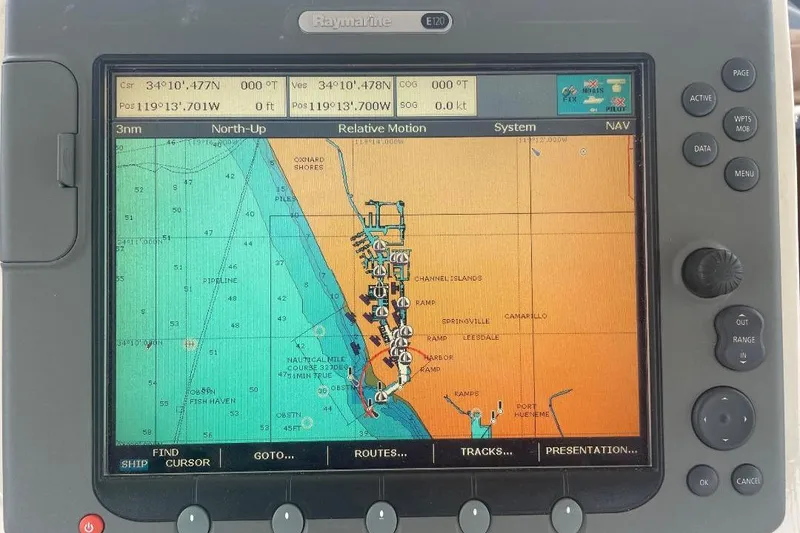 Slide: The Image of Raymarine navigation display on 1990 Offshore Yachts 55 Pilothouse, showing nautical chart and coordinates. - 36