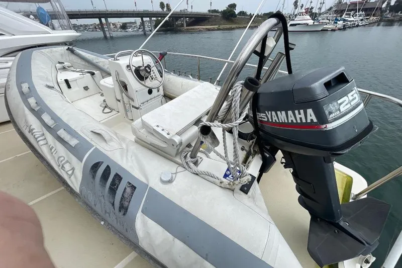 Slide: The Image of Inflatable boat with Yamaha 25 outboard motor on 1990 Offshore Yachts 55 Pilothouse. - 40