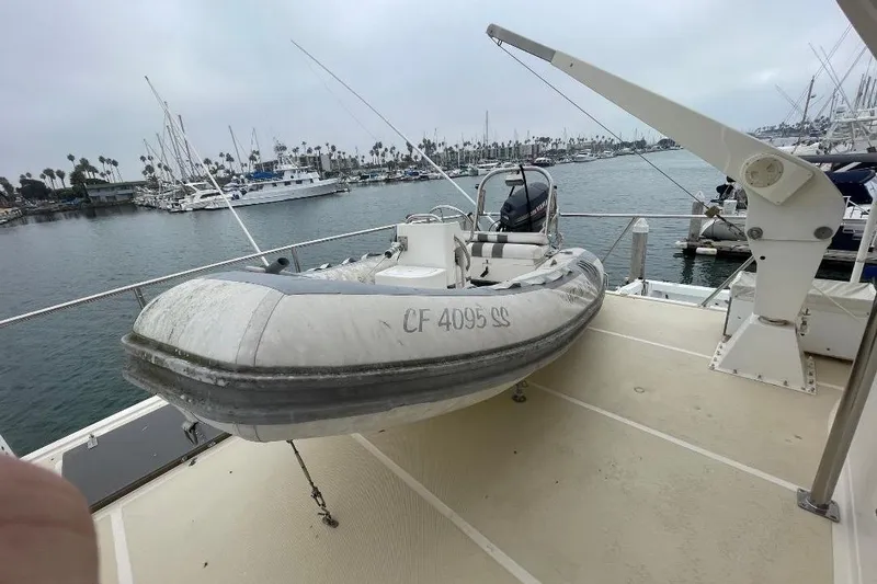 Slide: The Image of Inflatable boat on deck of 1990 Offshore Yachts 55 Pilothouse, docked at marina. - 41