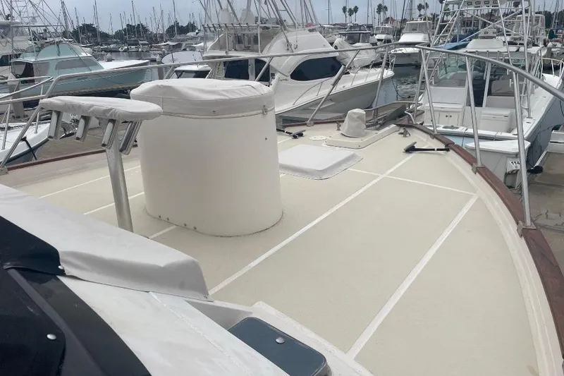 Slide: The Image of 1990 Offshore Yachts 55 Pilothouse deck view in marina with surrounding boats. - 43