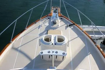 Slide: The Image of 1990 Offshore Yachts 55 Pilothouse bow with railing and deck details. - 44