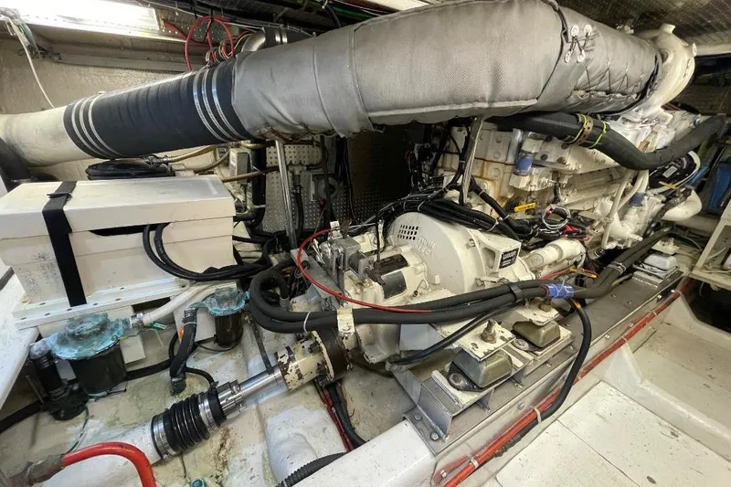 Slide: The Image of Engine room of a 1990 Offshore Yachts 55 Pilothouse, showcasing mechanical components. - 47