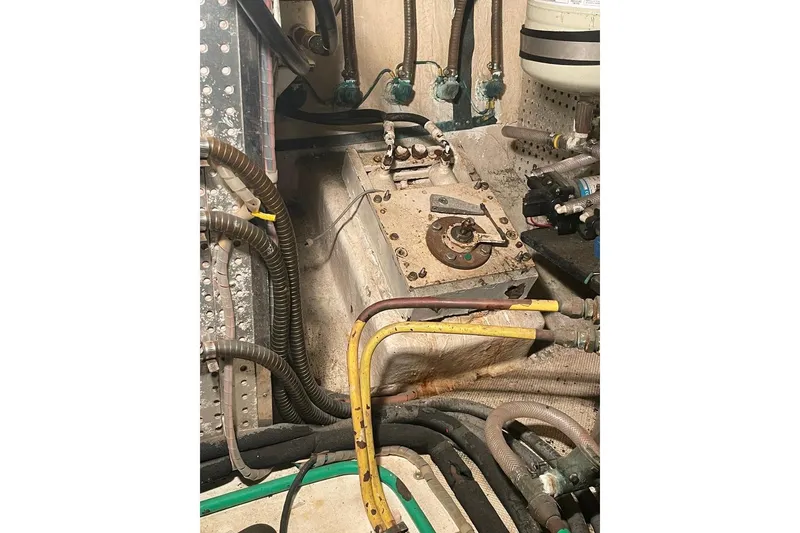 Slide: The Image of Engine room of 1990 Offshore Yachts 55 Pilothouse with various pipes and components. - 48