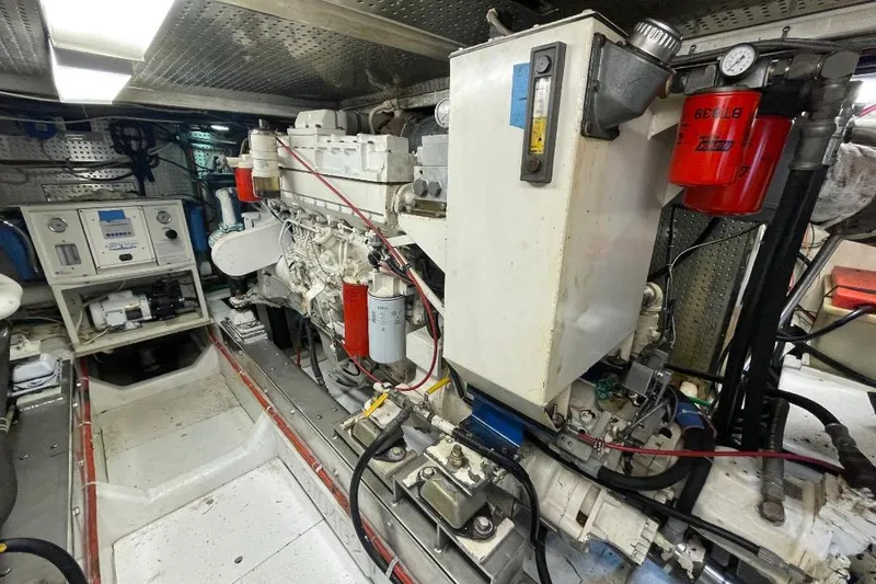 Slide: The Image of Engine room of a 1990 Offshore Yachts 55 Pilothouse, showcasing machinery and equipment. - 49
