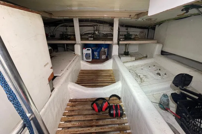 Slide: The Image of Engine room of 1990 Offshore Yachts 55 Pilothouse with equipment and tools. - 51