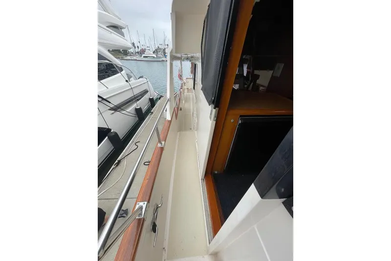 Slide: The Image of 1990 Offshore Yachts 55 Pilothouse side deck view at marina. - 54