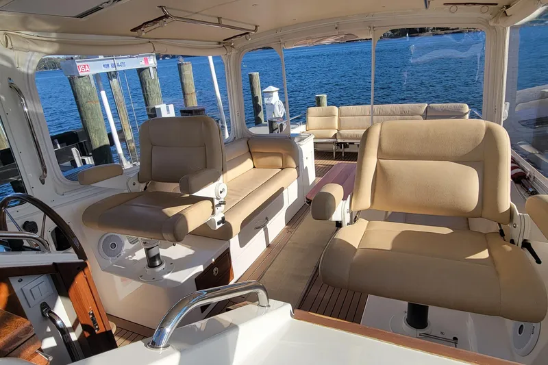 Slide: The Image of 2017 MJM 40z Downeast yacht interior with beige seating and ocean view. - 13