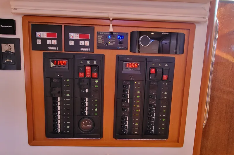 Slide: The Image of Electrical control panel on a 2017 MJM 40z Downeast boat, featuring digital displays and switches. - 21