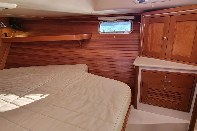 Slide: The Image of Cozy cabin interior of 2017 MJM 40z Downeast with wood paneling and storage cabinets. - 24