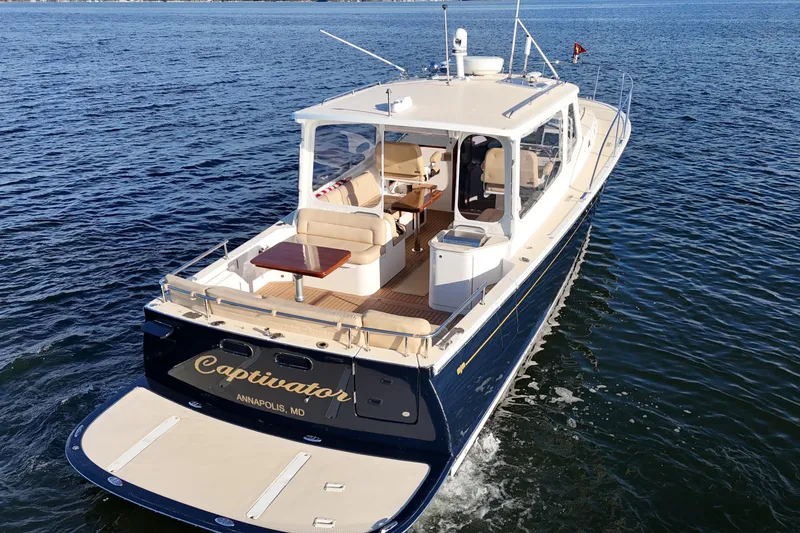 Slide: The Image of 2017 MJM 40z Downeast yacht cruising on open water, rear view. - 3