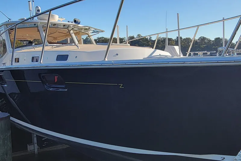 Slide: The Image of 2017 MJM 40z Downeast boat docked, showcasing sleek design and elegant structure. - 5