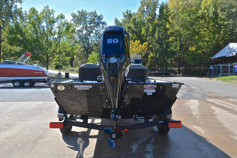 Slide: The Image of 2024 Bass Tracker Classic boat with a 50 HP engine, parked on a trailer. - 13