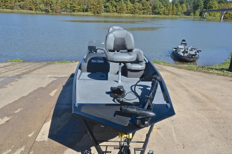 Slide: The Image of 2024 Bass Tracker Classic boat on a concrete ramp by a serene lake. - 17