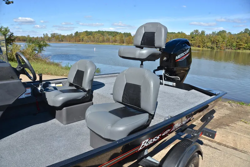 Slide: The Image of 2024 Bass Tracker Classic boat with Mercury engine by a scenic lake. - 18
