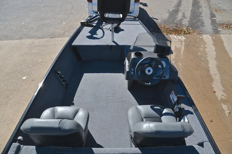 Slide: The Image of 2024 Bass Tracker Classic boat interior with steering wheel and seating. - 20