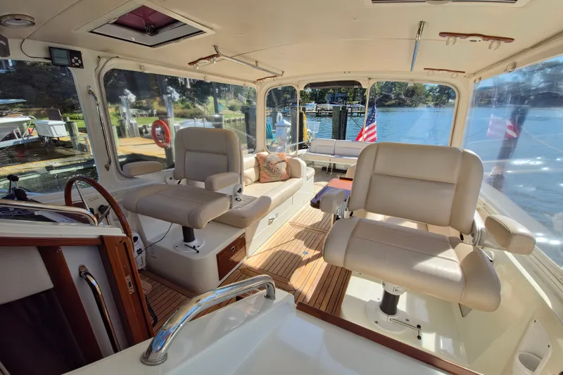 Slide: The Image of Interior of 2011 MJM 40z Downeast yacht with plush seating and scenic water view. - 15