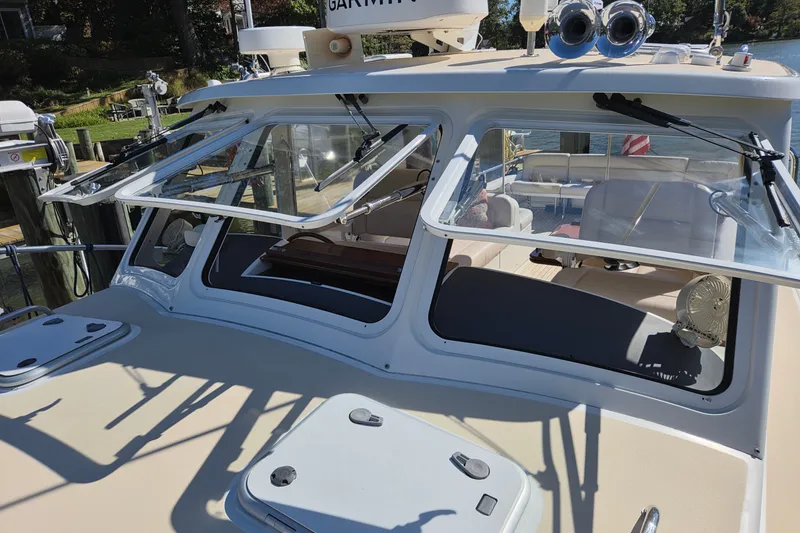 Slide: The Image of 2011 MJM 40z Downeast boat with open windows and visible interior seating. - 14