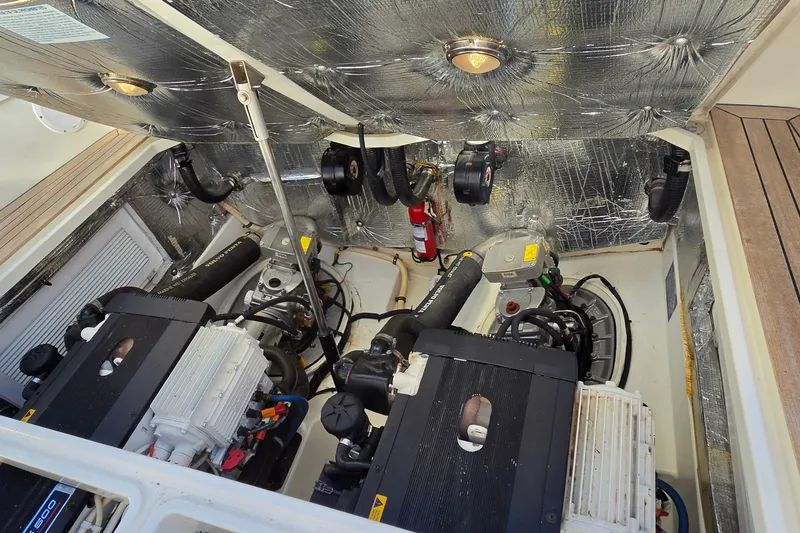 Slide: The Image of Engine compartment of a 2011 MJM 40z Downeast boat, showcasing dual engines and equipment. - 43