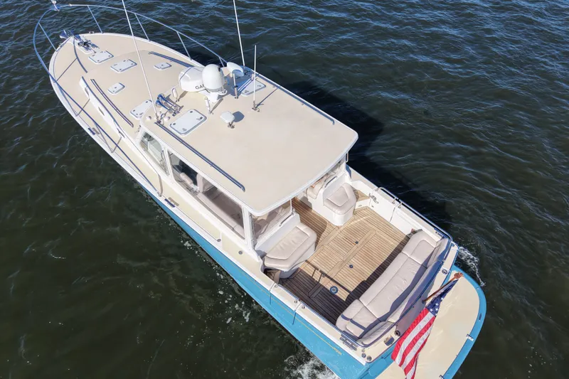 Slide: The Image of Aerial view of 2011 MJM 40z Downeast boat cruising on water. - 6