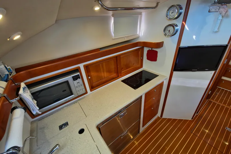 Slide: The Image of Luxurious 2011 MJM 40z Downeast yacht kitchen with modern appliances and elegant wood finish. - 25