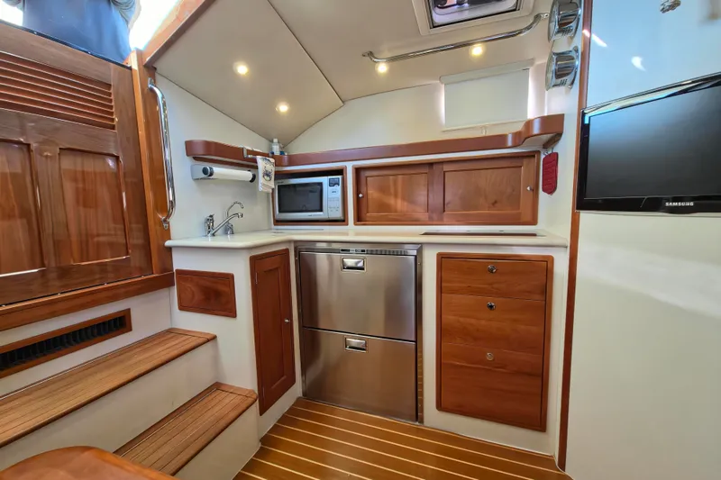 Slide: The Image of Luxurious 2011 MJM 40z Downeast yacht interior with wood cabinetry and modern appliances. - 26