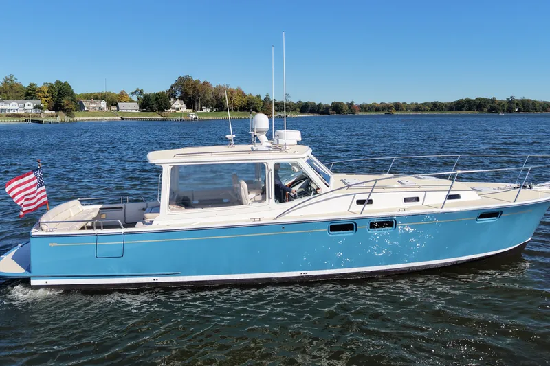 Slide: The Image of 2011 MJM 40z Downeast boat cruising on a sunny day with American flag. - 1