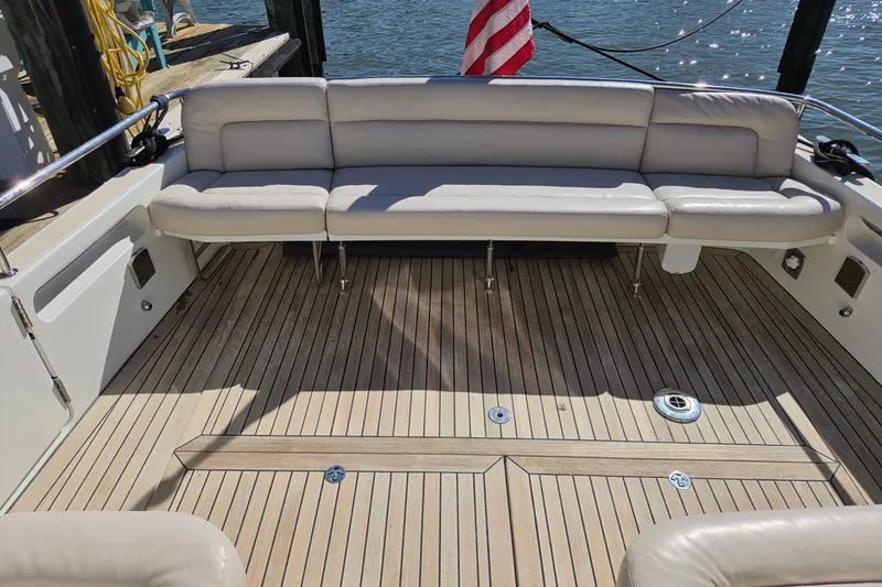 Slide: The Image of 2011 MJM 40z Downeast boat with teak deck and cushioned seating, docked by the water. - 22