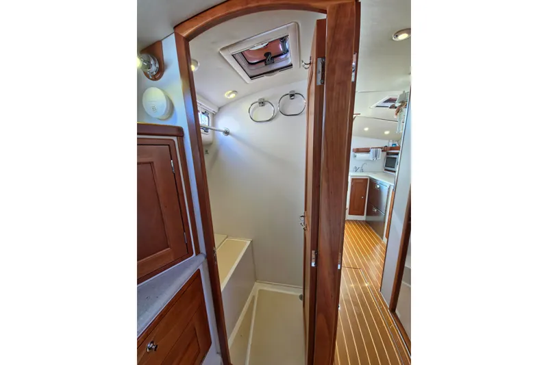 Slide: The Image of Interior of 2011 MJM 40z Downeast yacht, featuring wooden cabinetry and compact bathroom. - 36