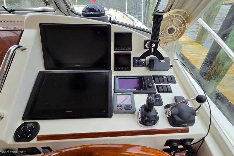 Slide: The Image of Control panel of a 2011 MJM 40z Downeast boat with navigation screens and controls. - 20