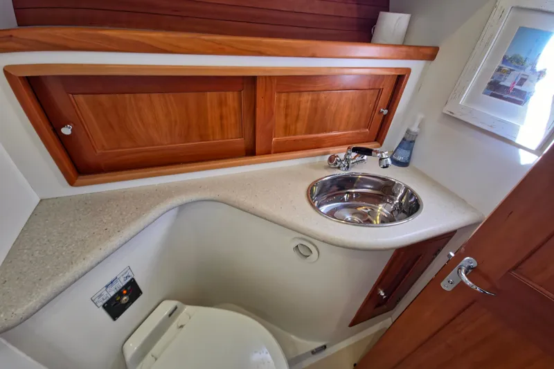 Slide: The Image of 2011 MJM 40z Downeast yacht bathroom with wooden cabinets and stainless steel sink. - 39