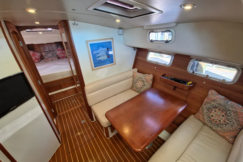 Slide: The Image of 2011 MJM 40z Downeast yacht interior with cozy seating and wooden table. - 23