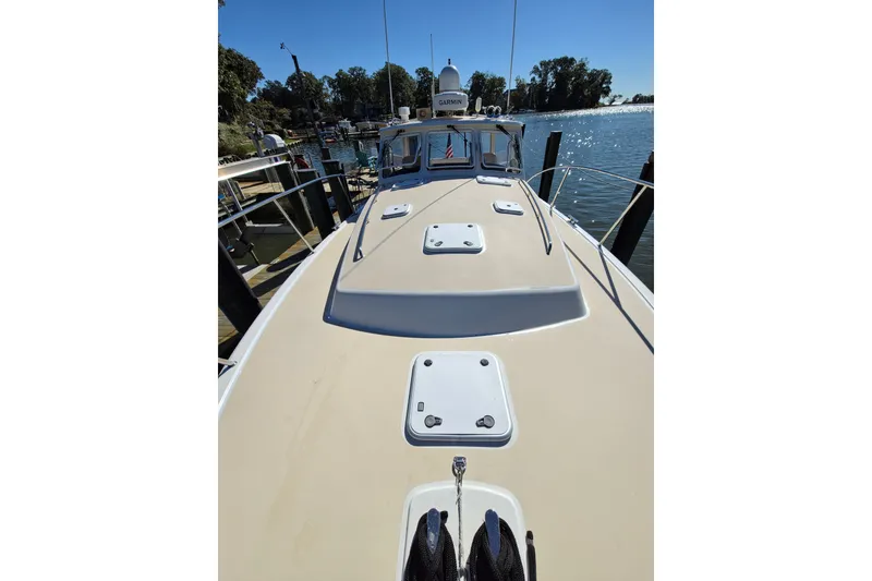 Slide: The Image of 2011 MJM 40z Downeast boat docked, showcasing deck and water view. - 10