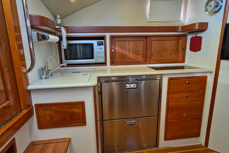 Slide: The Image of 2011 MJM 40z Downeast yacht kitchen with stainless appliances and wooden cabinetry. - 27