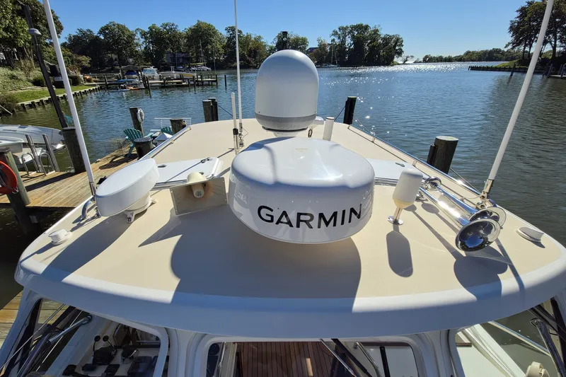 Slide: The Image of 2011 MJM 40z Downeast boat with Garmin equipment docked by a scenic waterfront. - 13