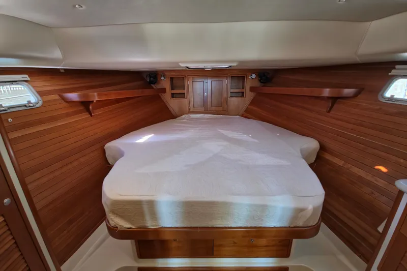 Slide: The Image of 2011 MJM 40z Downeast yacht cabin with wooden interior and cozy bed. - 31