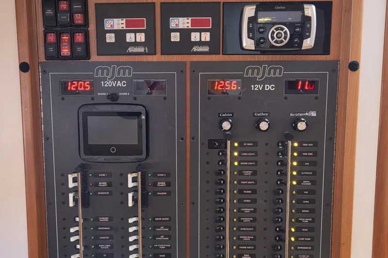 Slide: The Image of Electrical control panel of a 2011 MJM 40z Downeast boat, featuring 120VAC and 12VDC systems. - 30