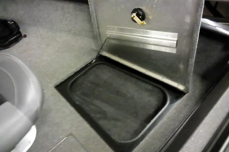 Slide: The Image of 2022 Tracker Pro Guide V-16 WT boat interior with storage compartment open. - 10