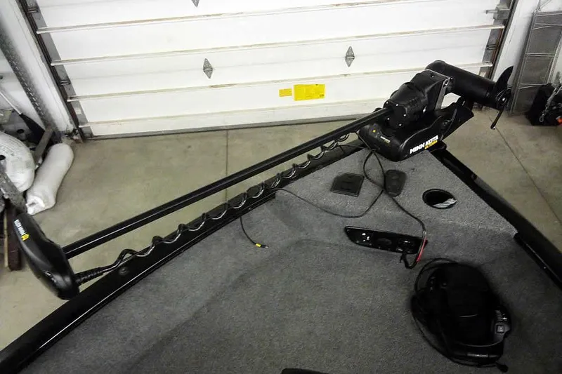 Slide: The Image of 2022 Tracker Pro Guide V-16 WT boat with Minn Kota trolling motor in garage. - 12