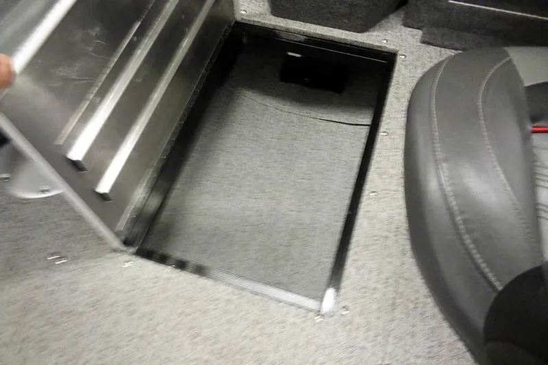 Slide: The Image of 2022 Tracker Pro Guide V-16 WT boat storage compartment with open lid and seating. - 16