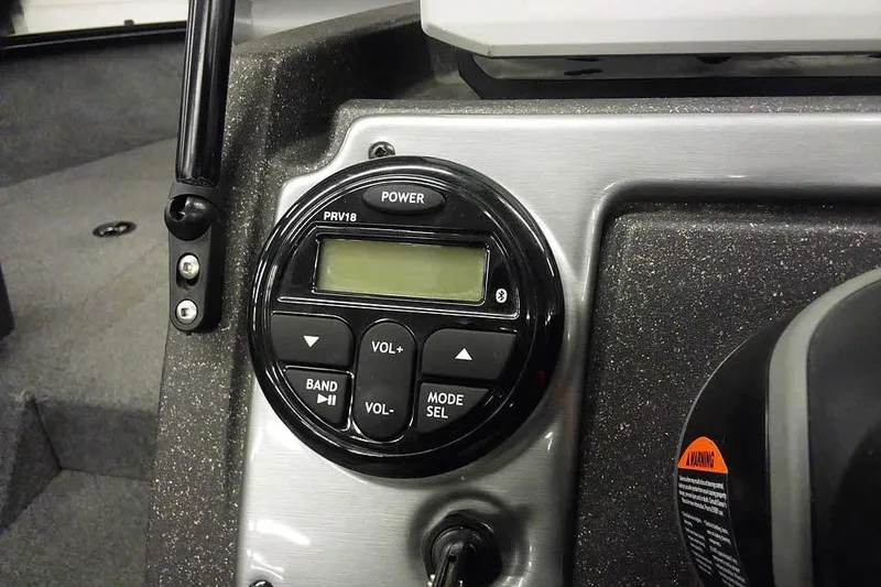 Slide: The Image of 2022 Tracker Pro Guide V-16 WT boat dashboard with audio control panel. - 24