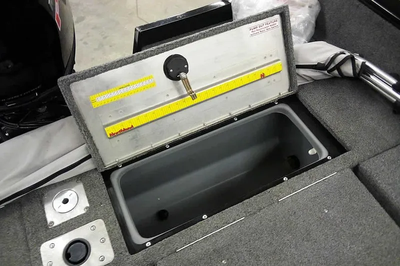 Slide: The Image of 2022 Tracker Pro Guide V-16 WT boat storage compartment with measuring ruler. - 28