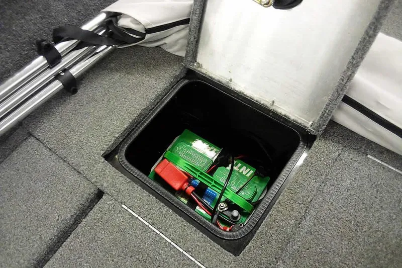 Slide: The Image of 2022 Tracker Pro Guide V-16 WT boat battery compartment with storage space. - 30