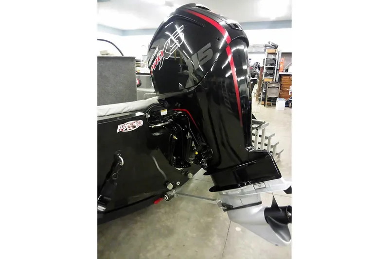 Slide: The Image of 2022 Tracker Pro Guide V-16 WT boat with powerful outboard motor in showroom. - 4