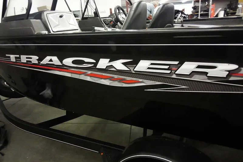 Slide: The Image of 2022 Tracker Pro Guide V-16 WT boat with sleek black exterior and bold graphics. - 6