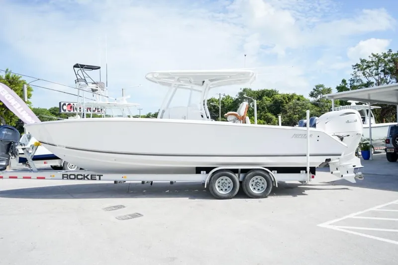 Slide: The Image of 2026 Jupiter 30 boat with twin Yamaha engines on open water. - 1